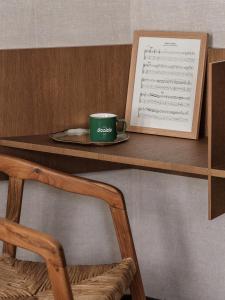 a wooden table topped with a book and a coffee cup at HOTEL SOOKIE in Paris