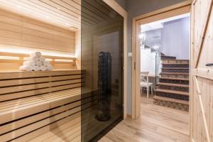 a sauna with wood paneling and a staircase at udanypobyt House Million Dollar View in Gliczarów