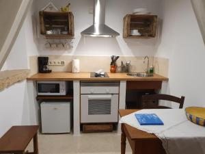 a small kitchen with a counter and a sink at Agroturisme Na Martina in Portopetro