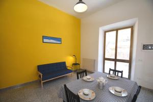 a living room with a table and a couch at PRIMAVERA TRILO - Zona mare con spazio esterno, clima e posto auto in Marina di Campo
