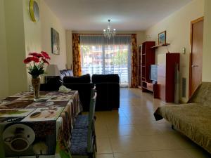 a living room with a table and a couch at Apartment Santa Cristina in Lloret de Mar