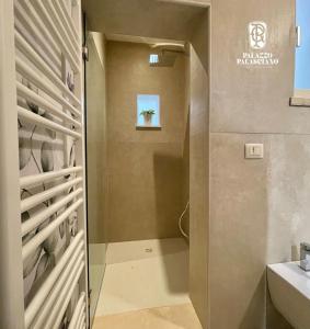 a bathroom with a walk in shower and a sink at Palazzo Palasciano in Monopoli