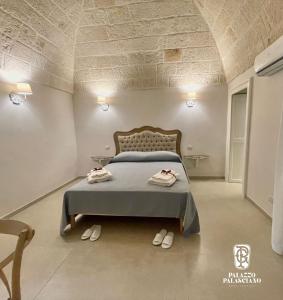 a bedroom with a bed with two towels on it at Palazzo Palasciano in Monopoli