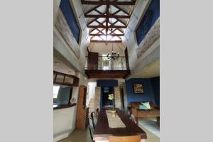 a dining room with a table and chairs and a balcony at Luxury Villa Nelspruit in Nelspruit