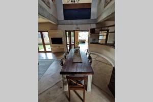 a dining room with a long table and chairs at Luxury Villa Nelspruit in Nelspruit