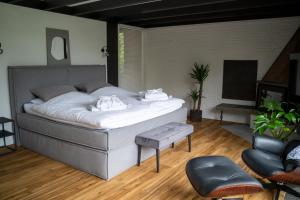 a bedroom with a large bed with white sheets at hygge Niederrhein in Rees