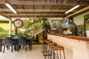 a restaurant with a bar with chairs and a table at פרדייז ברמה in Had Nes