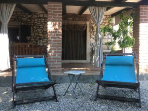 two chairs and a table in front of a house at Casa romana in Poreč