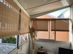 a room with two windows with blinds on them at Appartement Arcachon en hyper centre in Arcachon