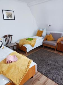 "ハルカーニャ"にあるÁgnes Apartmanokのベッド2台とソファが備わる客室です。