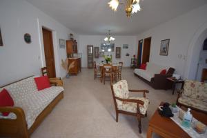 a living room with couches and a dining room at Katiana's House in Aliki
