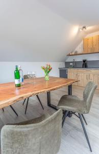 a kitchen with a wooden table and two chairs at Pension Talblick in Sulz am Neckar