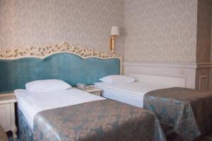 Postel nebo postele na pokoji v ubytování Olympic Hotel