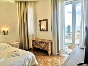 a hotel room with two beds and a balcony at Villa Giannina B&B in Taormina