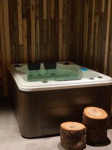 a bath tub with two logs in a room at Casitas de Madera O Loureiro in Noya