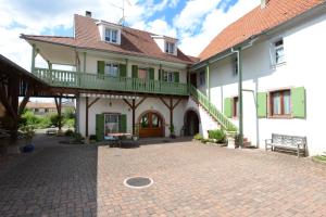 a large house with a balcony and a patio at La Maison Oberlin in Horbourg