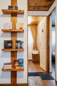 a room with wooden shelves on the wall at Cabana La Tata Gheo in Porumbacu de Sus