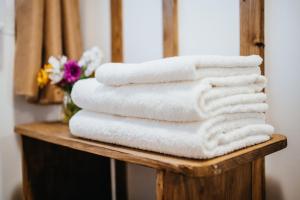 a pile of towels sitting on a table in a bathroom at Cabana La Tata Gheo in Porumbacu de Sus +50 photos