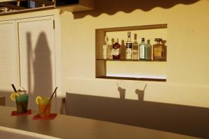 a counter with some drinks on a shelf in a kitchen at Villa Pina in Bari