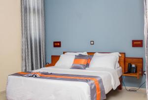 
A bed or beds in a room at PREMIUM HOTEL DOUALA
