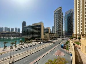a city street with cars on the road and buildings at The Smart Concierge - Bahar 6 in Dubai