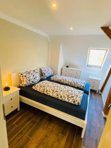 a bedroom with a bed with two pillows on it at HaRe Ferienwohnungen in Langeneß