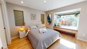 a bedroom with a bed with two towels on it at @ Marbella Lane - SJ Designer Home 3BR Ldry+P in San Jose