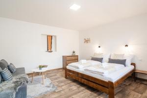 1 dormitorio con 2 camas y sofá en Ubytování 121 - Hlohovec, en Hlohovec