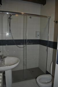 a bathroom with a shower and a sink and a toilet at Hotel Rural Los Perales in San Vitero +76 photos