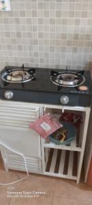 a kitchen counter with a stove and a sink at Annettes Place in Naivasha
