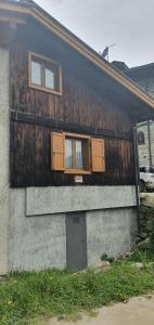 a building with doors and windows on the side of it at Baita di montagna Stavel in Vermiglio