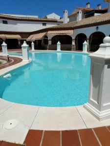 a large blue swimming pool in a building at Casa D Mis Dos Gitanillas in Córdoba