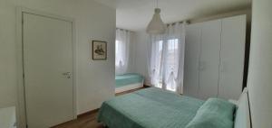 a bedroom with a bed and a window at Appartamenti Lino in Caorle