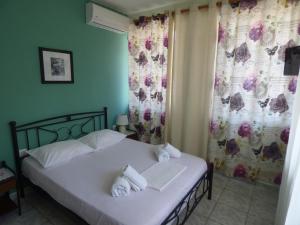 a bedroom with a bed with towels on it at Anna Apartments in Argostoli