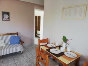 a dining room with a wooden table and chairs at Anna Apartments in Argostoli