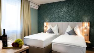 Postel nebo postele na pokoji v ubytování Hotel Karolina