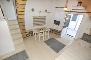 A television and/or entertainment centre at Rhodes Archangelos Traditional village house in with private yard