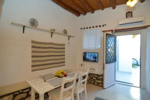A television and/or entertainment centre at Rhodes Archangelos Traditional village house in with private yard