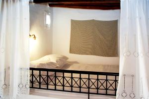 A bed or beds in a room at Rhodes Archangelos Traditional village house in with private yard