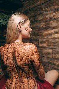 a woman with skulls on her face sitting in a room at Spa-hotel Dobrynia in Odesa