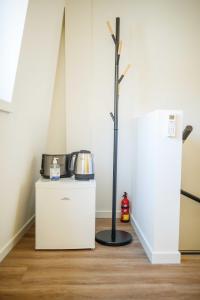 a room with a coffee maker on a refrigerator at Deluxe 35m2 City Center Suite - with Views in Den Bosch
