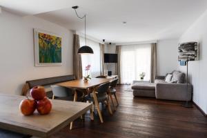 a living room with a table and chairs and a couch at da Peatala Apartments in Serfaus