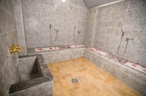 a bathroom with a shower with a tub and a sink at Hotel Tildi Hotel & Spa in Agadir