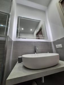 a bathroom with a white sink and a mirror at Maresole Cefalù in Cefalù +50 photos