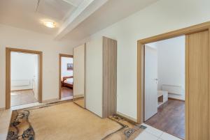 a hallway with sliding doors and a mirror at VILLA ALEXANDRA in Kumbor +10 photos