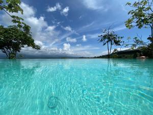 a large body of water with trees in the background at Casa Libertinn in Manuel Antonio