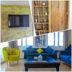 a living room with a blue couch and a tv at Villa Island Zembra in El Haouaria