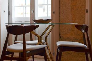 a dining room table with chairs and a window at Oporto Chic&Cozy - Ribeira in Porto