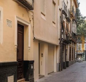 an empty street in a city with buildings at Loving Seville San Juan 3 in Seville