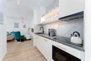 a kitchen with a sink and a stove top oven at Apartmán Ostrava in Ostrava
